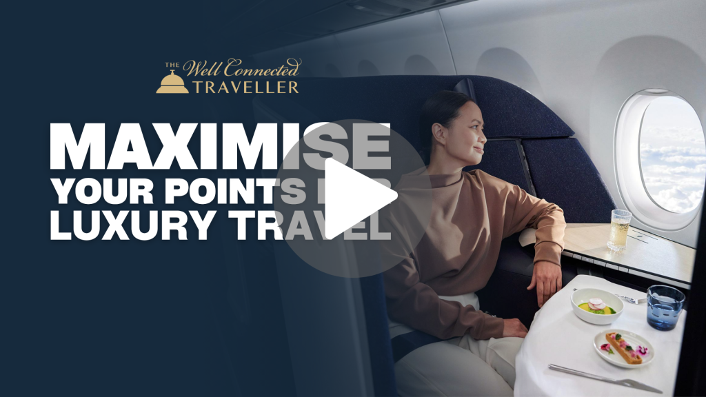 Hero banner: woman in a business-class airplane seat, dining, with bold white text 'MAXIMISE YOUR POINTS IN LUXURY TRAVEL' and The Well Connected Traveller logo on a dark background.